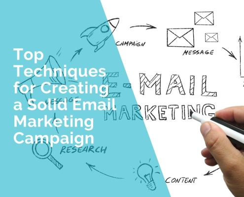 A hand is writing a solid email marketing campaign