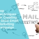 A hand is writing a solid email marketing campaign