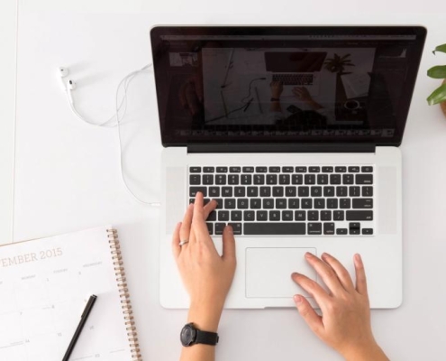 Woman typing on a laptop