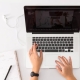 Woman typing on a laptop