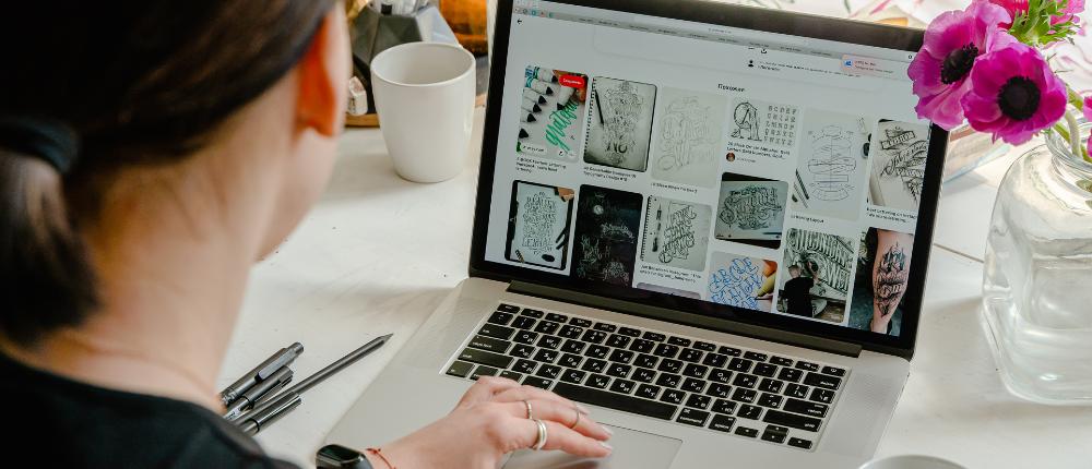 A female entrepreneur looking for website design inspiration on her laptop