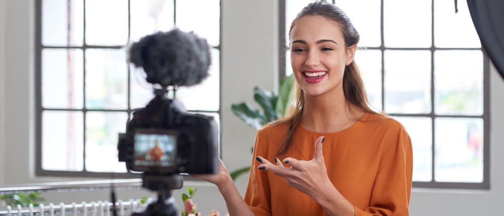 A young woman recording video to sell it as a digital products